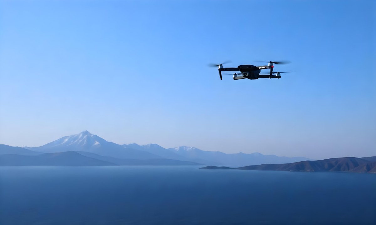 A Blue Drone Flying Over The Mountains With Mountains In The Background And A Clear Blue Sky 15 A6a4