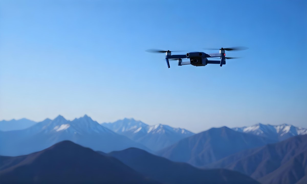 A Blue Drone Flying Over The Mountains With Mountains In The Background And A Clear Blue Sky 8 4c08