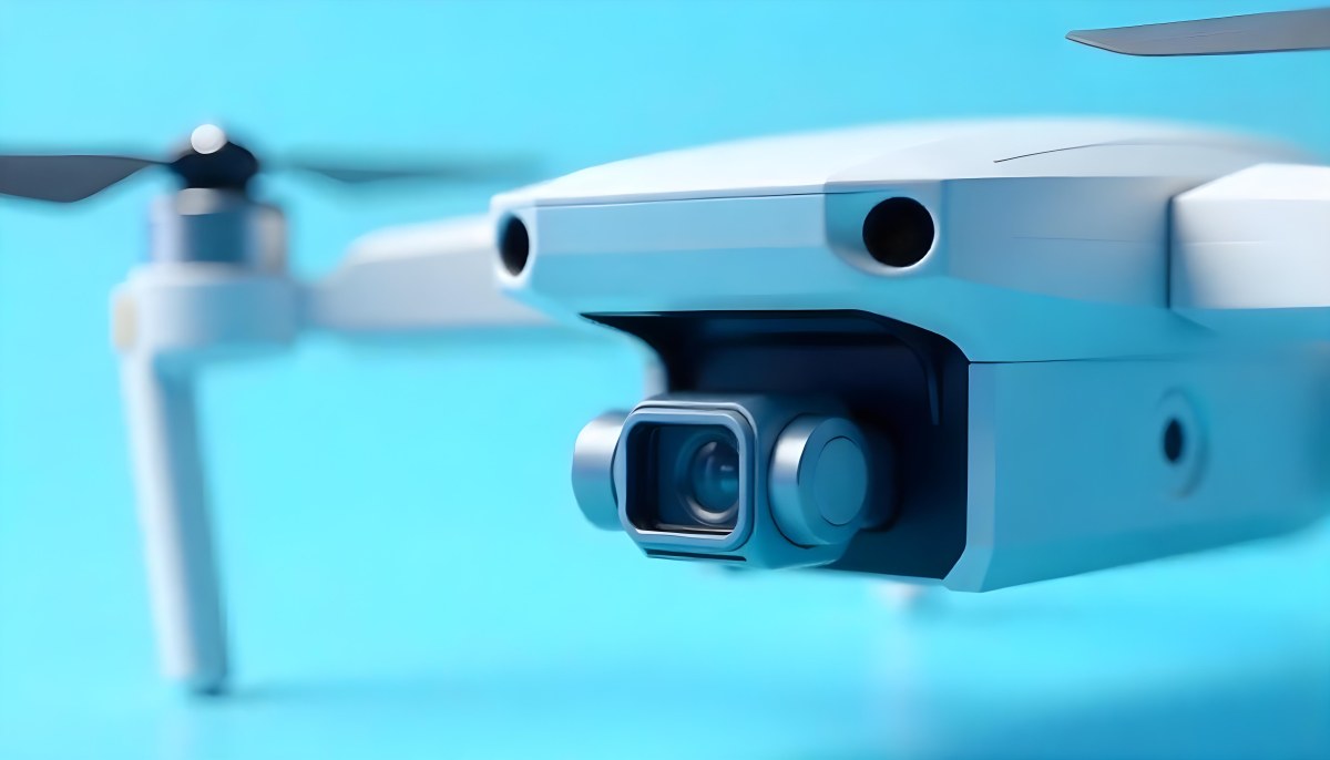 A Close Up Of A Drone Camera With A Lens And Blue Body Mounted On A White Drone With A Light Blue Background 6 Ff14