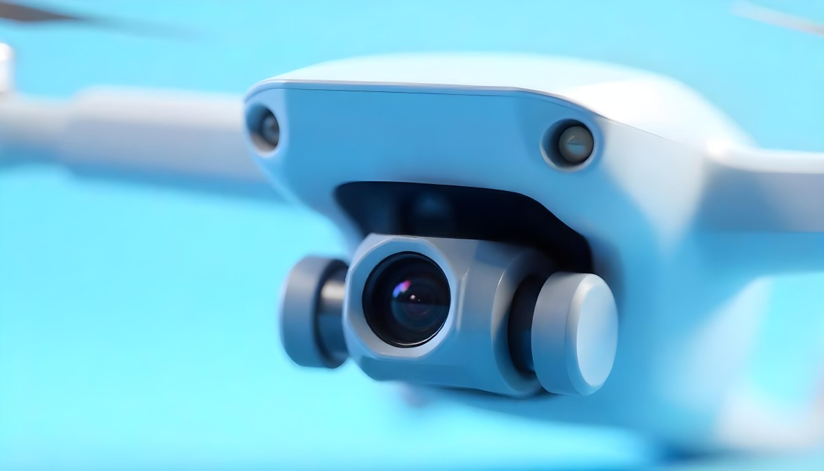 A Close Up Of A Drone Camera With A Lens And Blue Body Mounted On A White Drone With A Light Blue Background 8 Ef41