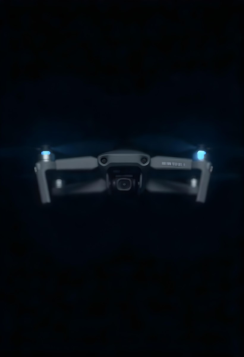 A Gray Mavic 2 Drone With Blue Propellers In The Air The Sky Is Black 6 F409