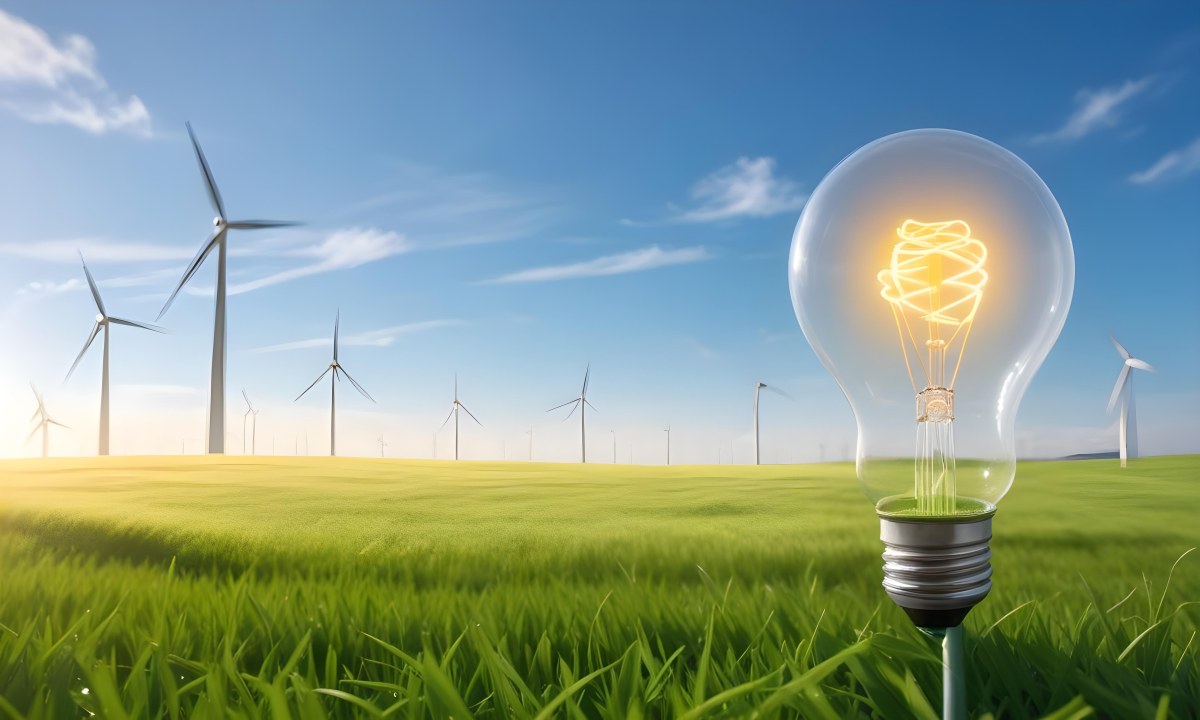 A Hand Holding A Light Bulb With Green Grass On Top Of It Solar Panels In A Green Field And A Blue Sky 90 6622