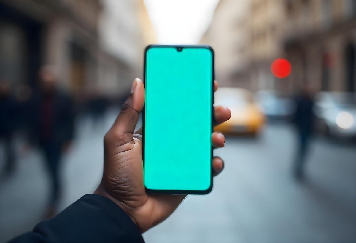 Black Man Holding A Smartphone With A Blank Turquoise Screen The Background Is A Blurred City Street 8 5a17