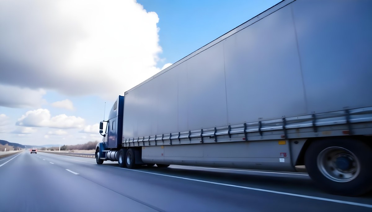 A Blue Semi Truck On A Highway With Motion Blur The Sky Is Black With Some Clouds Daytime 20 E84e