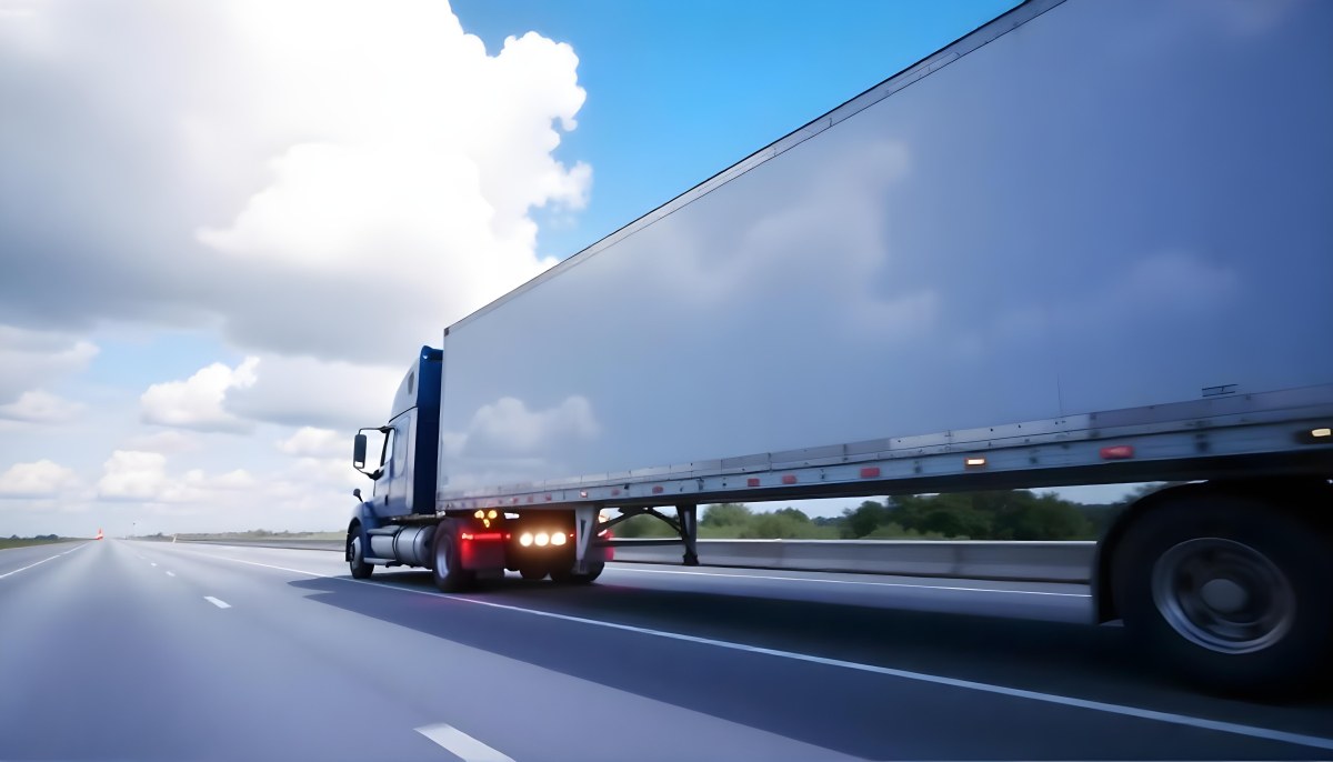 A Blue Semi Truck On A Highway With Motion Blur The Sky Is Black With Some Clouds Daytime 26 D6b7