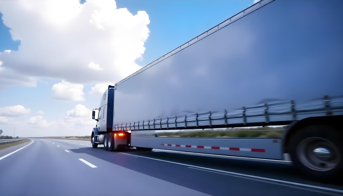 A Blue Semi Truck On A Highway With Motion Blur The Sky Is Black With Some Clouds Daytime 32 D607