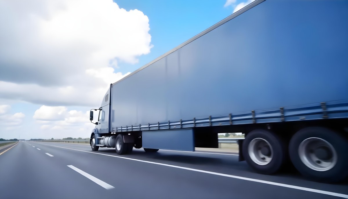 A Blue Semi Truck On A Highway With Motion Blur The Sky Is Black With Some Clouds Daytime 6 E495