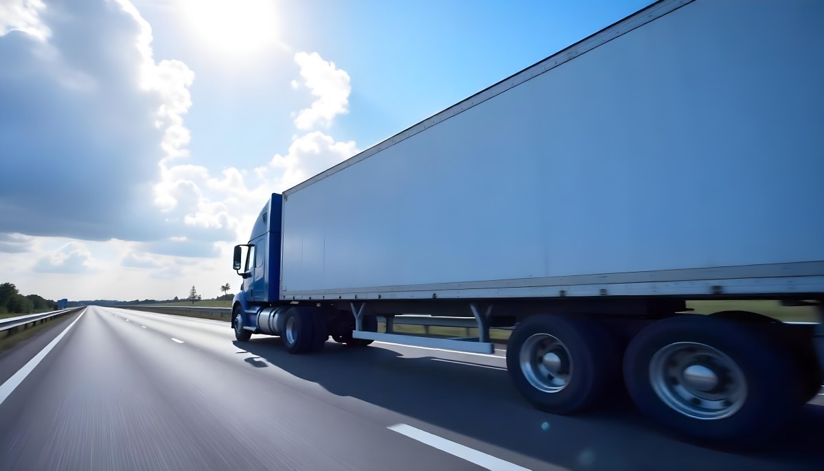 A Blue Semi Truck On A Highway With Motion Blur The Sky Is Black With Some Clouds Daytime 8 D802