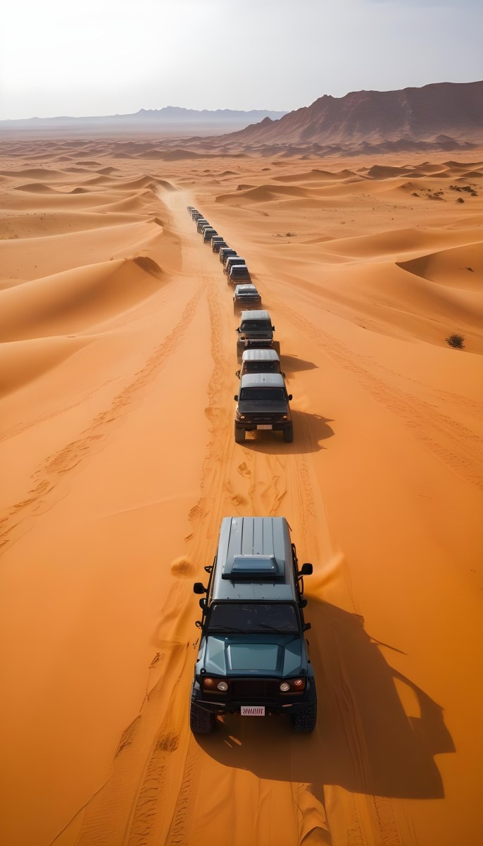 A Convoy Of Off Road Vehicles Driving Through A Vast Sandy Desert Landscape With Rolling Dunes 9 55bd