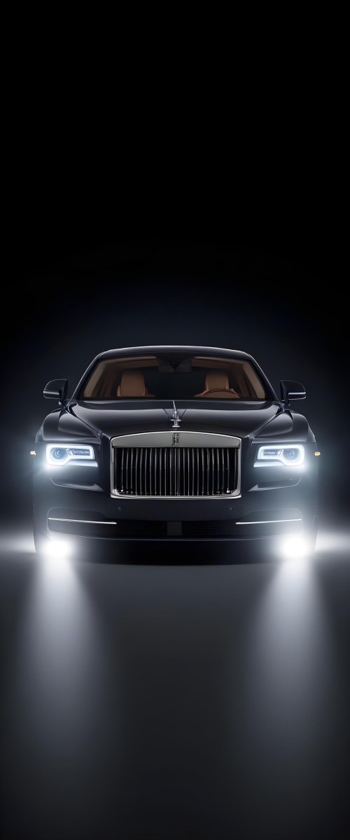 A Sleek Dark Colored Luxury Sedan With A Prominent Grille Featuring The Rolls Royce Logo Illuminated Headlights And A Minimalist Elegant Design 5 1f19