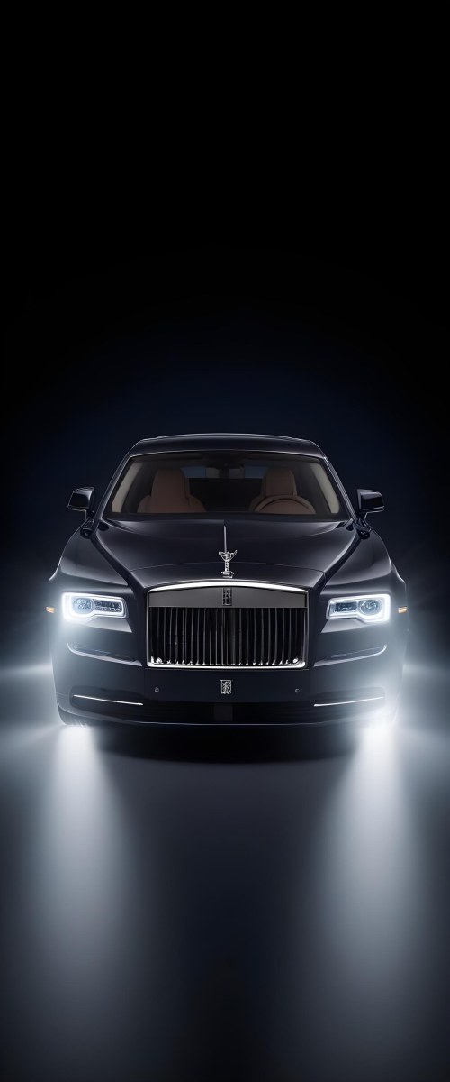 A Sleek Dark Colored Luxury Sedan With A Prominent Grille Featuring The Rolls Royce Logo Illuminated Headlights And A Minimalist Elegant Design 7 64d6