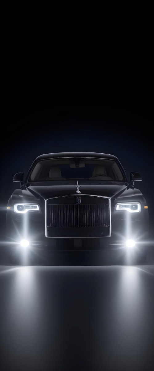 A Sleek Dark Colored Luxury Sedan With A Prominent Grille Featuring The Rolls Royce Logo Illuminated Headlights And A Minimalist Elegant Design 8 E73d