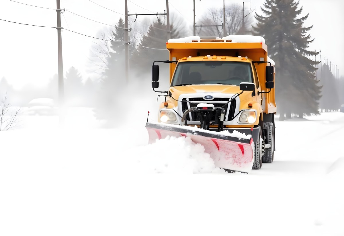 A Yellow Snowplow Truck Plowing Snow On A Road The Background Is A Snowy Landscape With Trees And Power Lines 13 C2f9
