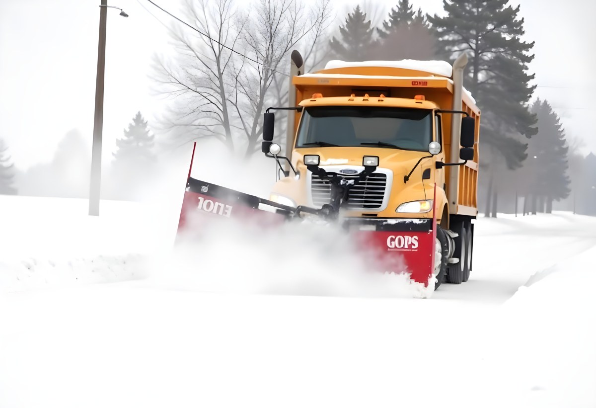 A Yellow Snowplow Truck Plowing Snow On A Road The Background Is A Snowy Landscape With Trees And Power Lines 18 6656