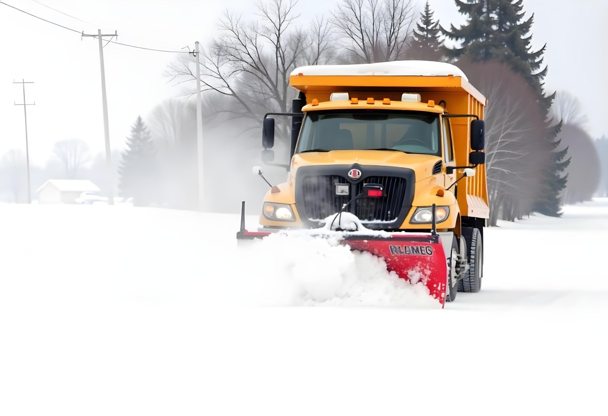 A Yellow Snowplow Truck Plowing Snow On A Road The Background Is A Snowy Landscape With Trees And Power Lines 20 6311