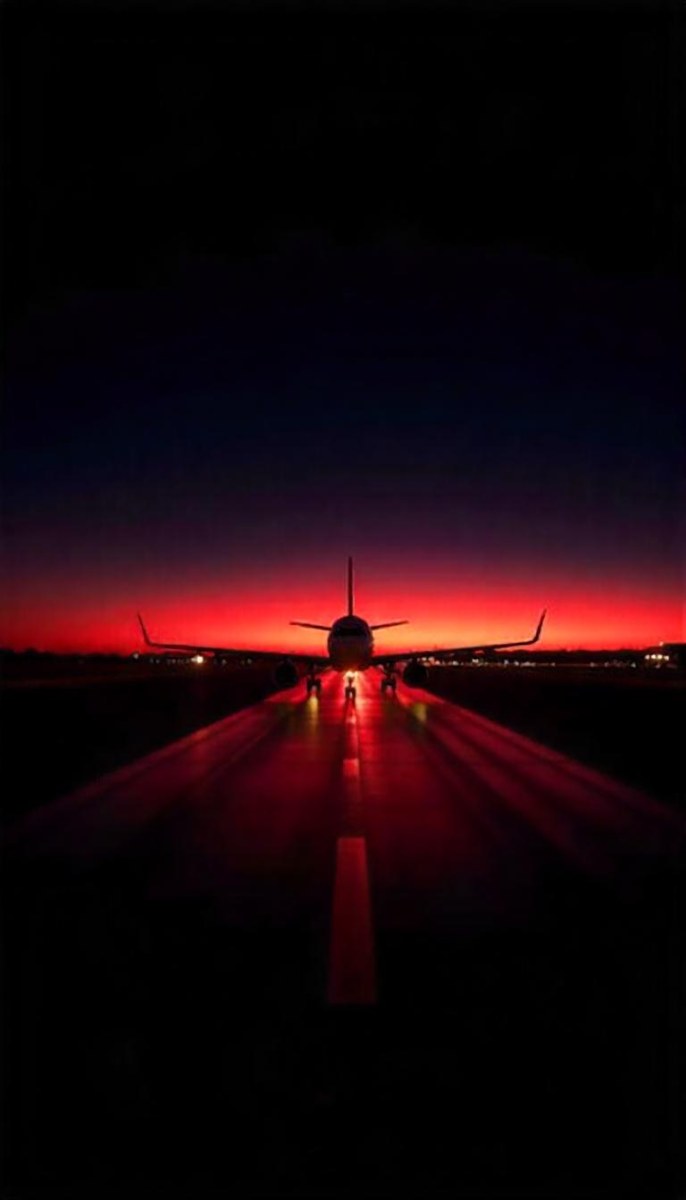 Airplane On A Runway At Night Red And Black Color Palette The Sky Is Dark With A Red Glow Dramatic Lighting 9 514b