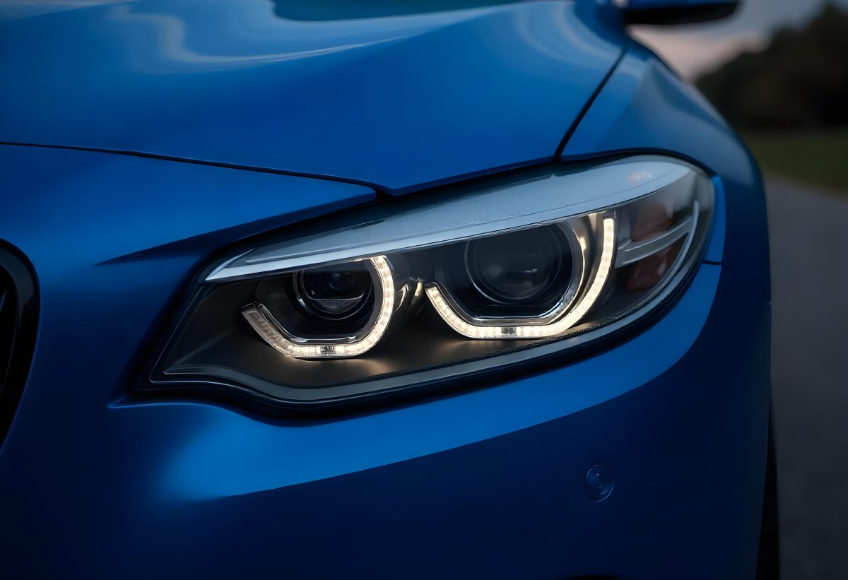 Car Headlight With Chrome Trim And Led Lights Blue Car Paint In The Background Close Up Shot 26 6e44
