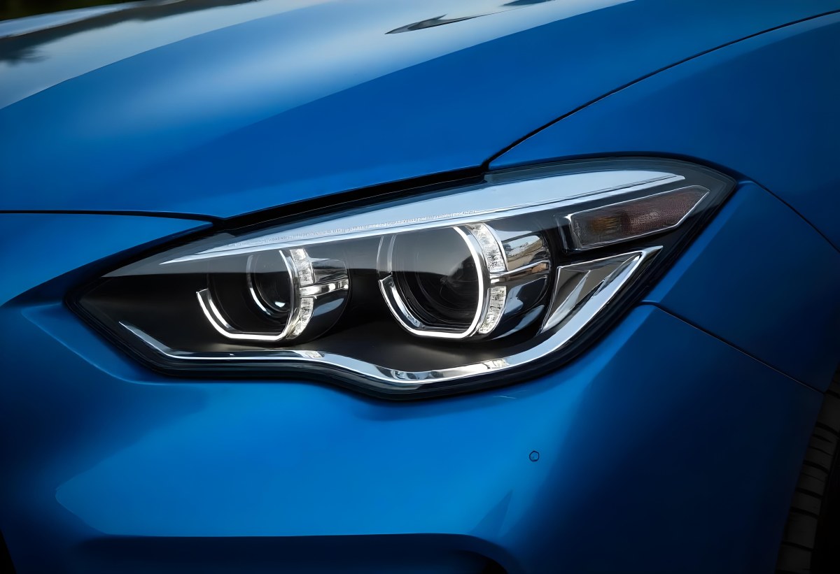 Car Headlight With Chrome Trim And Led Lights Blue Car Paint In The Background Close Up Shot 3 4cc1