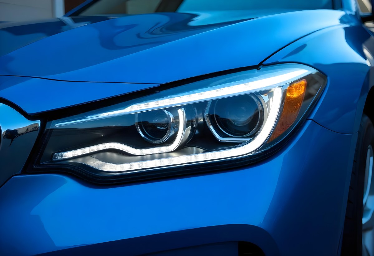 Car Headlight With Chrome Trim And Led Lights Blue Car Paint In The Background Close Up Shot 33 204f