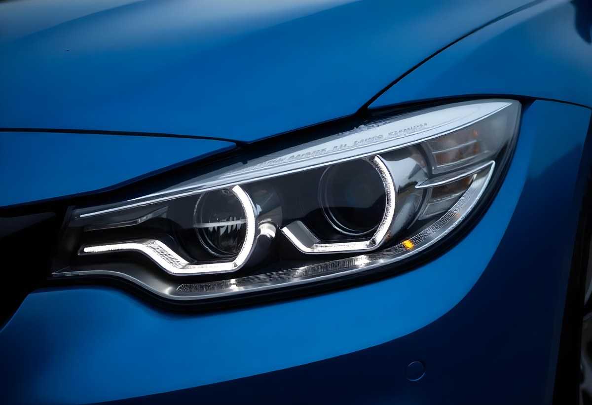 Car Headlight With Chrome Trim And Led Lights Blue Car Paint In The Background Close Up Shot 5 C010