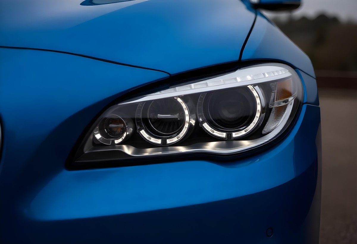 Car Headlight With Chrome Trim And Led Lights Blue Car Paint In The Background Close Up Shot 52 B465