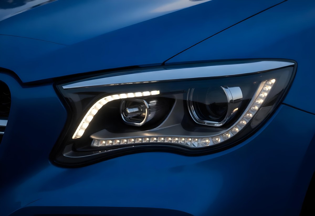 Car Headlight With Chrome Trim And Led Lights Blue Car Paint In The Background Close Up Shot 7 Dd9d