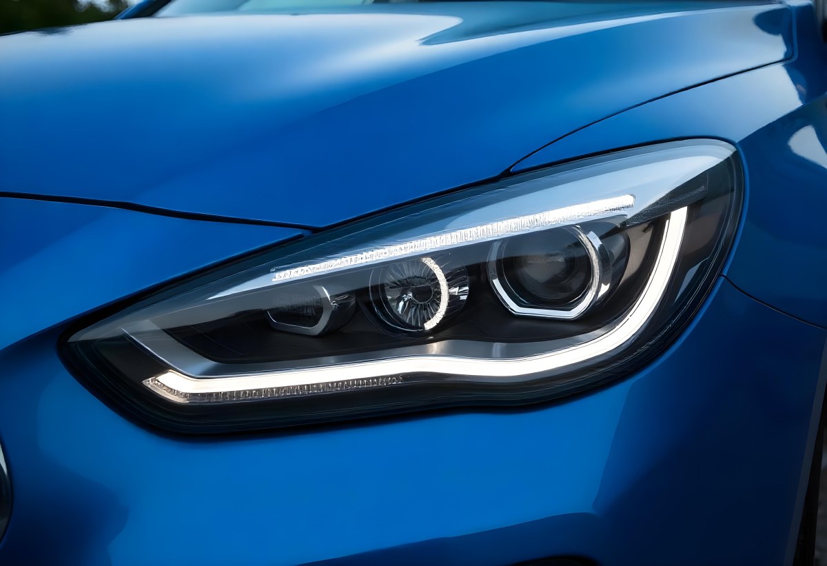 Car Headlight With Chrome Trim And Led Lights Blue Car Paint In The Background Close Up Shot 9 F92d