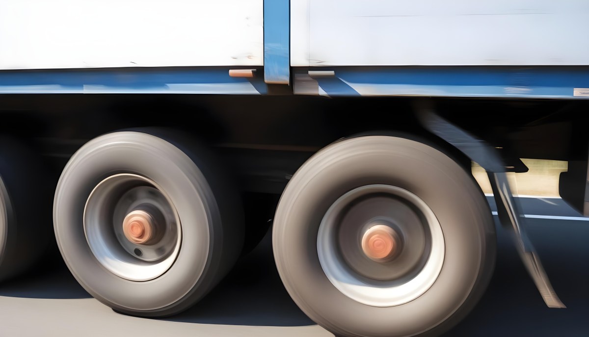 Truck Wheels In Motion Showing The Blur Of Movement With A Blue And White Truck Body Above On A Road 13 9fff