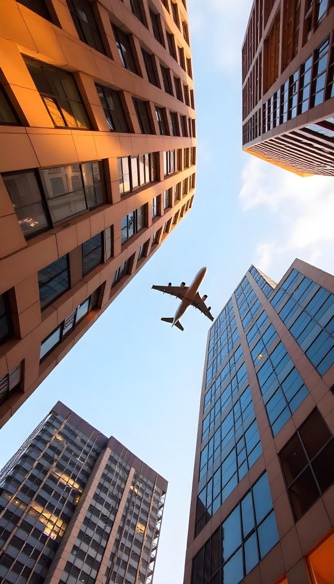 Two Airplanes Flying Between Skyscrapers Low Angle Shot Clear Sky Urban Environment City Landscape Commercial Aviation Modern Architecture Travel Concept 16 D3ce