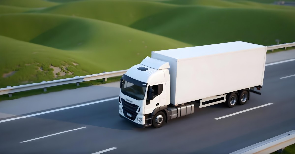 White Truck On The Road With A Green Container Green Hills In The Background Sunny Day Commercial Transport Highway 25 Fcc6