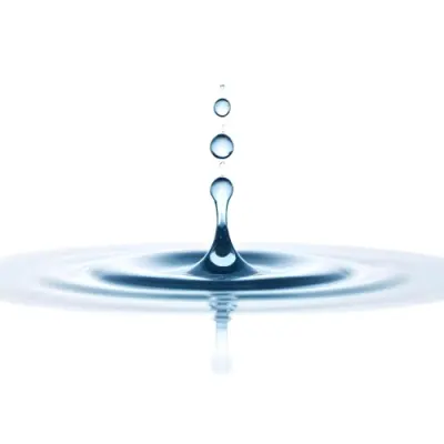 A Water Drop Falling Into A Body Of Water Creating Ripples Isolated On A White Background Studio Shot High Speed Photography 37 A3de