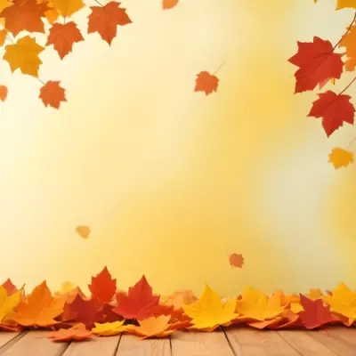 Colorful Autumn Leaves Falling On A Blurred Yellow And Orange Background With A Wooden Surface In The Foreground 12 09e5