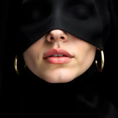 A 22 Year Old Caucasian Woman With Black Lips And Golden Earrings Partially Covered By A Black Cloth In A Black Background 5 5d16