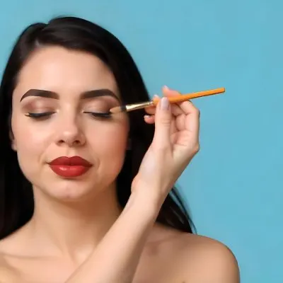 A 22 Year Old Hispanic Woman With Blue Hair Applying Makeup With A Brush Black Lipstick Closed Eyes In A Black Background 14 6491