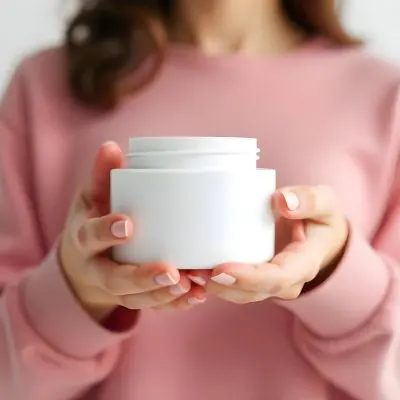 A 25 Year Old Caucasian Woman Holding A White Cream Jar With Both Hands Light Pink Nail Polish Light Pink Clothes White Background 4 0d9c