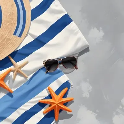 A Beach Towel With Blue Stripes A Straw Hat With Sunglasses A Sunscreen Bottle And Some Starfish On A Gray Marble Background 7 22ec