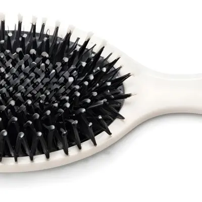 A Black Hair Brush With White Bristles Placed On A Marble Countertop 1 E42f