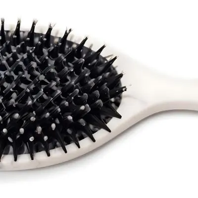 A Black Hair Brush With White Bristles Placed On A Marble Countertop 3 205a