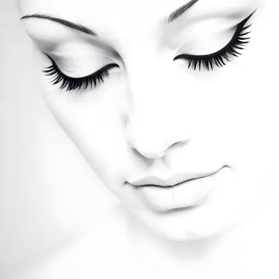 A Black Young Woman Age 22 With Closed Eyes Long Eyelashes And White Eyeliner In A Black Background 5 2c7d