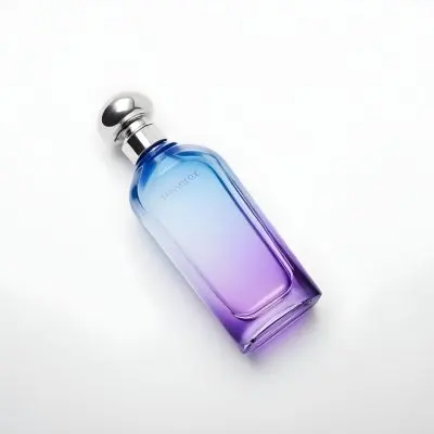 A Blue And Purple Gradient Perfume Bottle With A Silver Cap On A White Background 7 4c59