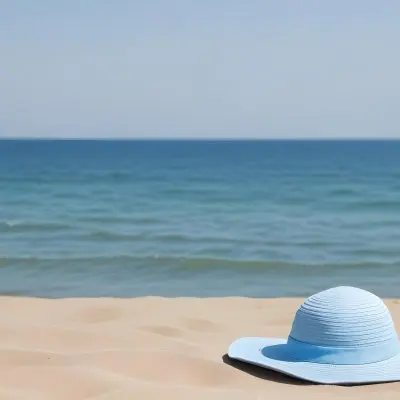 A Blue Sun Hat And Blue Sunglasses On A Sandy Beach With A Blue Sea And Sky In The Background 5 360b