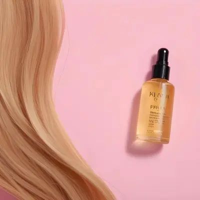 A Bottle Of Hair Oil And A Strand Of Blonde Hair On A Pink Background 32 D4dc