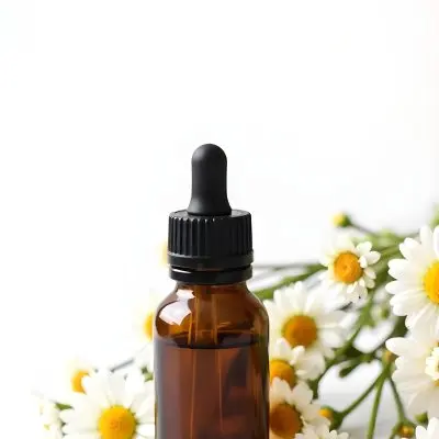 A Bottle Of Yellow Liquid Surrounded By White Daisy Flowers On A Light Background 30 0352