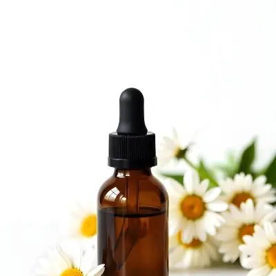 A Bottle Of Yellow Liquid Surrounded By White Daisy Flowers On A Light Background 9 6b3a