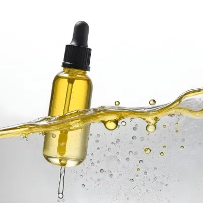 A Bottle Of Yellow Liquid With A Dropper Inside A Transparent Liquid With Bubbles White Background 5 285a