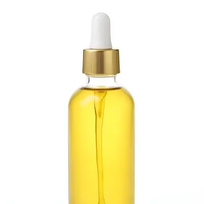 A Bottle With Yellow Oil And A Golden Dropper With A White Cap On A White Background 15 86fc