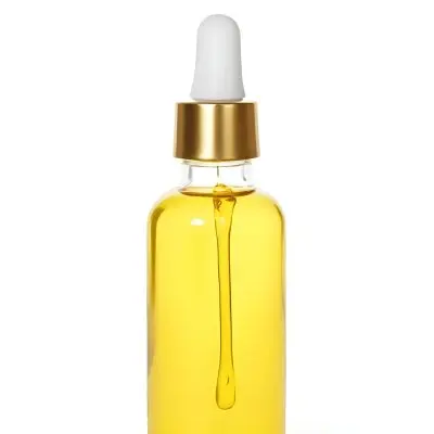 A Bottle With Yellow Oil And A Golden Dropper With A White Cap On A White Background 4 1f19
