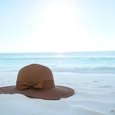 A Brown Sun Hat With A Ribbon On A White Sand Beach Turquoise Sea And Clear Sky In The Background 20 8b5e