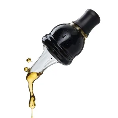 A Close Up Of A Black And Transparent Glass Dropper With A Golden Liquid Drop Falling Isolated On A Black Background Showcasing The Texture And Color 23 D925