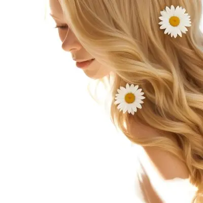 A Close Up Of Long Wavy Blonde Hair With White Daisy Flowers Woven Throughout In Bright Sunlight 24